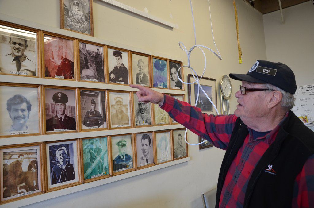Bob Weiss points to his portrait on the Wall of Fame<br/>